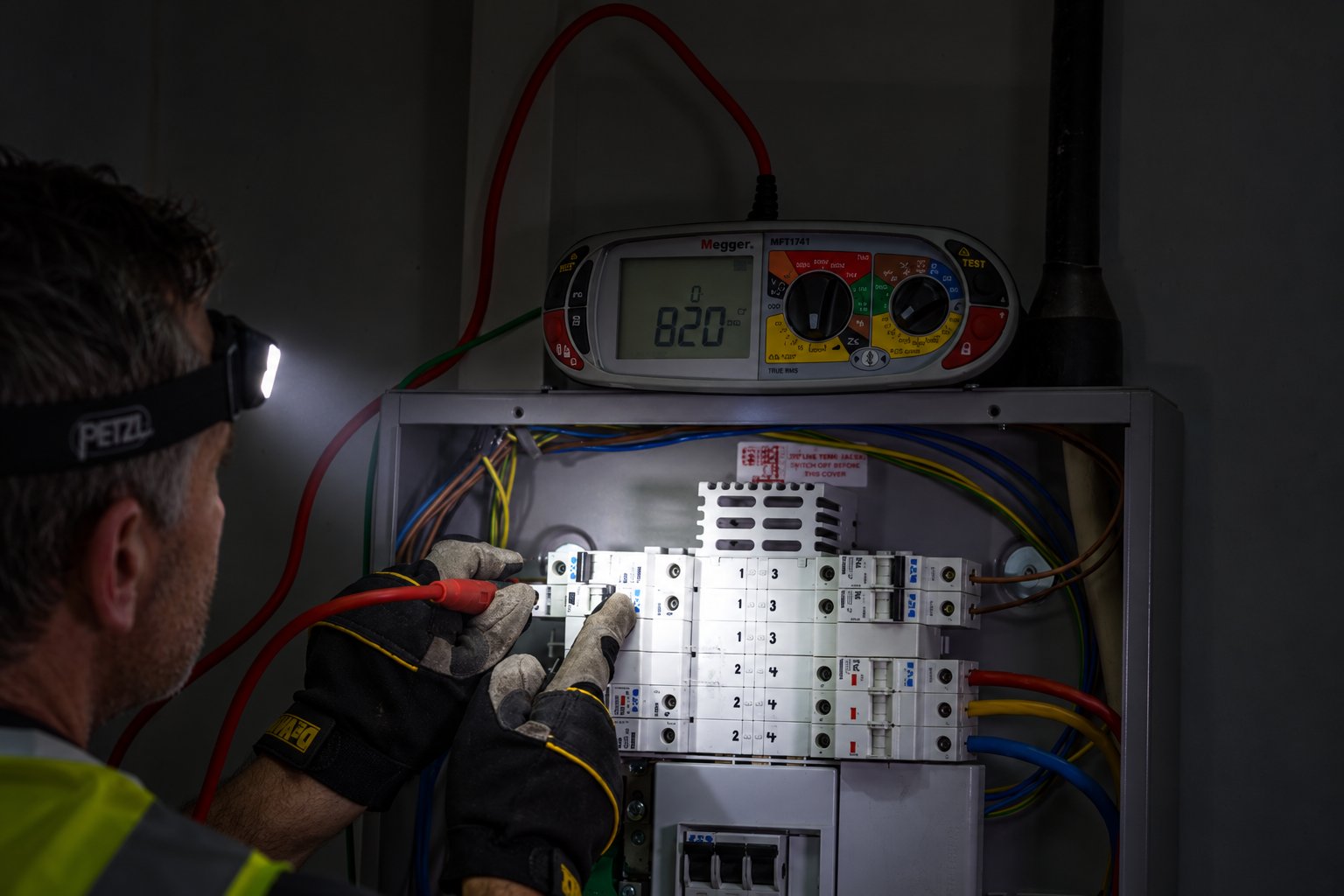 Electrician testing a consumer unit with a multifunction tester
